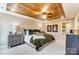 The main bedroom featuring a decorative wood tray ceiling, plush bedding and lots of natural light at 4223 Black Ct # 195, Harrisburg, NC 28075