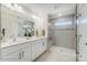 Modern bathroom with double sinks, quartz countertops, and a frameless glass shower at 4235 Black Ct # 197, Harrisburg, NC 28075