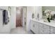 A bright, contemporary bathroom featuring double vanity sinks, white cabinetry, and modern fixtures and decor at 4235 Black Ct # 197, Harrisburg, NC 28075