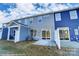 Back exterior of the property showing the siding, windows and patio at 4235 Black Ct # 197, Harrisburg, NC 28075