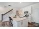 Contemporary kitchen with an island, modern appliances, and a view of the staircase at 4235 Black Ct # 197, Harrisburg, NC 28075