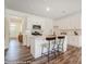 Stylish kitchen featuring white cabinetry, stainless steel appliances, and a center island at 4235 Black Ct # 197, Harrisburg, NC 28075