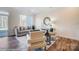 Well-lit living room features an open floorplan with seating areas and hardwood floors at 4235 Black Ct # 197, Harrisburg, NC 28075