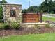 Harrisburg Village entrance sign with stone base and landscaping at 4235 Black Ct # 197, Harrisburg, NC 28075