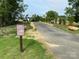 Harrisburg Village walking trail sign with stone edging along the trail at 4235 Black Ct # 197, Harrisburg, NC 28075