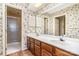 Bathroom with double sinks, and a glass-enclosed shower at 4309 Woodglen Ln, Charlotte, NC 28226