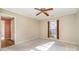 Bedroom with white carpet, ceiling fan, and window with wood shutters at 4309 Woodglen Ln, Charlotte, NC 28226