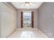 Bright bedroom with large windows, neutral-toned walls, a ceiling fan and ample closet space at 4309 Woodglen Ln, Charlotte, NC 28226