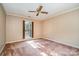 Bright bedroom with a ceiling fan, tan carpet, and window with wood shutters at 4309 Woodglen Ln, Charlotte, NC 28226