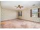 Bedroom with neutral-toned walls, large windows, and a ceiling fan at 4309 Woodglen Ln, Charlotte, NC 28226