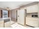 Functional kitchen featuring white appliances, linoleum flooring and ample cabinet storage space at 4309 Woodglen Ln, Charlotte, NC 28226