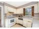 Functional kitchen featuring white appliances, linoleum flooring and ample cabinet storage space at 4309 Woodglen Ln, Charlotte, NC 28226