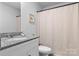 Bathroom featuring granite countertop, toilet, and shower with curtain at 4496 Springs Rd, Conover, NC 28613