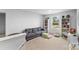 Comfortable living room with gray sofa, bookcases, and natural light from the window at 4496 Springs Rd, Conover, NC 28613