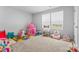 Bright playroom with carpet, toys and natural light from two windows at 4496 Springs Rd, Conover, NC 28613