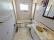 Bathroom with white tile, a tub with a shower, and a marbled sink countertop at 4801 Kipling Dr, Charlotte, NC 28212