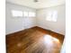 Bright bedroom featuring hardwood floors and ample natural light from multiple windows at 4801 Kipling Dr, Charlotte, NC 28212