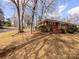 Ranch style home with brick exterior and mature trees at 4801 Kipling Dr, Charlotte, NC 28212