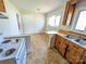 View of the functional kitchen with wooden cabinets, countertops, a breakfast bar, and a vintage oven at 4801 Kipling Dr, Charlotte, NC 28212