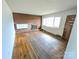 Bright living room with hardwood floors, a brick fireplace, and a large window with plenty of natural light at 4801 Kipling Dr, Charlotte, NC 28212