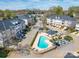 Aerial view of townhome community featuring a swimming pool and well-manicured landscaping and ample parking at 6724 Mallard Park Dr, Charlotte, NC 28262