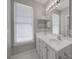 Bathroom with double vanity, large mirror, and bright natural light at 6724 Mallard Park Dr, Charlotte, NC 28262