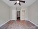 Spacious bedroom featuring wood-look floors, ceiling fan, and neutral paint at 6724 Mallard Park Dr, Charlotte, NC 28262