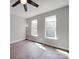 Bedroom features wood-look flooring and two windows with natural light at 6724 Mallard Park Dr, Charlotte, NC 28262