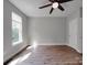 Cozy bedroom with wood-look floors, ceiling fan and a large window at 6724 Mallard Park Dr, Charlotte, NC 28262