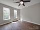 Bedroom with two windows and wood-look floors, offering natural light at 6724 Mallard Park Dr, Charlotte, NC 28262