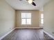 Bright bedroom featuring a large window, ceiling fan, neutral walls, and laminate flooring at 6724 Mallard Park Dr, Charlotte, NC 28262