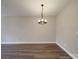 Bright dining room featuring a modern chandelier and hardwood floors offers a cozy space for Gathering meals at 6724 Mallard Park Dr, Charlotte, NC 28262