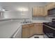 Functional kitchen featuring ample laminate countertop space and wood cabinetry with modern appliances at 6724 Mallard Park Dr, Charlotte, NC 28262