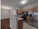 Open kitchen with stainless steel appliances, and laminate countertops, seamlessly flowing into dining area at 6724 Mallard Park Dr, Charlotte, NC 28262