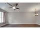 Inviting living room with natural light from the large window, complemented by hardwood floors and modern ceiling fan at 6724 Mallard Park Dr, Charlotte, NC 28262