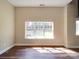 Living room features hardwood floors and a large window that provides ample natural light and recessed lighting at 6724 Mallard Park Dr, Charlotte, NC 28262