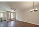 Spacious living room featuring hardwood flooring, ceiling fan, and ample natural light at 6724 Mallard Park Dr, Charlotte, NC 28262