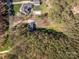 A bird's-eye view shows the property nestled among dense trees, with a pool and well-maintained lawns at 7025 Ridgeway Rd, Stanley, NC 28164
