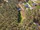 High-angle aerial view of a home surrounded by dense forest, showcasing privacy and natural beauty at 7025 Ridgeway Rd, Stanley, NC 28164