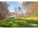 A wide, well-kept backyard offers ample green space and privacy, showcasing the home's exterior at 7025 Ridgeway Rd, Stanley, NC 28164