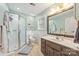 Bathroom with a light wall color, toilet, brown cabinet, and glass shower at 7025 Ridgeway Rd, Stanley, NC 28164
