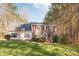 Attractive two-story brick and siding home featuring black shutters, a manicured lawn, and surrounded by a wooded landscape at 7025 Ridgeway Rd, Stanley, NC 28164