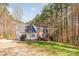 A two story home with a multi-car garage and a well maintained lawn surrounded by mature trees at 7025 Ridgeway Rd, Stanley, NC 28164