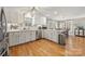 Open kitchen showcases white cabinets, modern appliances, quartz countertops, and hardwood floors at 7025 Ridgeway Rd, Stanley, NC 28164