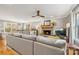 Spacious living room boasts a fireplace, large sofa, backyard views, and hardwood floors at 7025 Ridgeway Rd, Stanley, NC 28164
