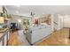 Comfortable living room boasts hardwood floors, modern furnishings, and bright natural light from large windows at 7025 Ridgeway Rd, Stanley, NC 28164
