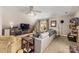 Spacious living room with a modern entertainment center, carpet, ceiling fan, and neutral walls at 7025 Ridgeway Rd, Stanley, NC 28164