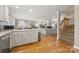 Open layout blends kitchen, living, and dining areas, featuring hardwood floors and natural light at 7025 Ridgeway Rd, Stanley, NC 28164