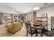 Large living room featuring carpet, neutral walls, windows with light and dark curtains, and a fan at 7025 Ridgeway Rd, Stanley, NC 28164