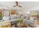 Open concept living room displays a large sofa, hardwood floors, and open access to the kitchen at 7025 Ridgeway Rd, Stanley, NC 28164